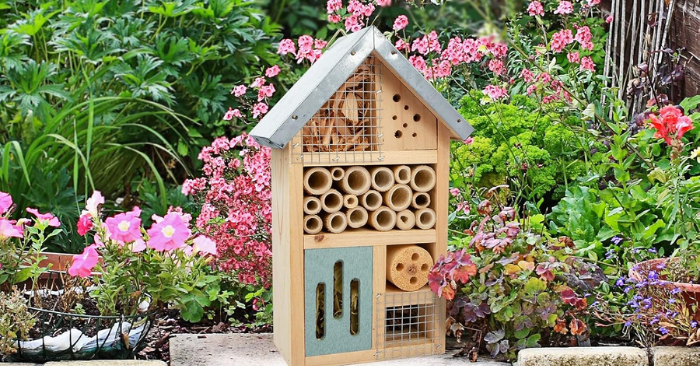 A wooden box in a house name: Bee hotel shape in a garden patio.